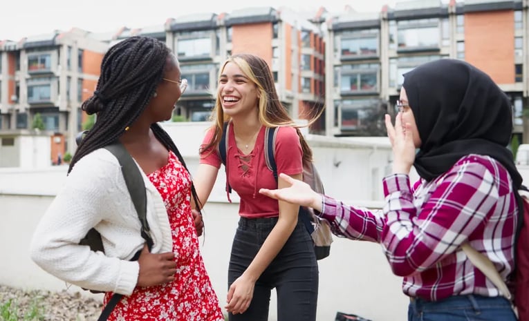 Friends talking and laughing in campus