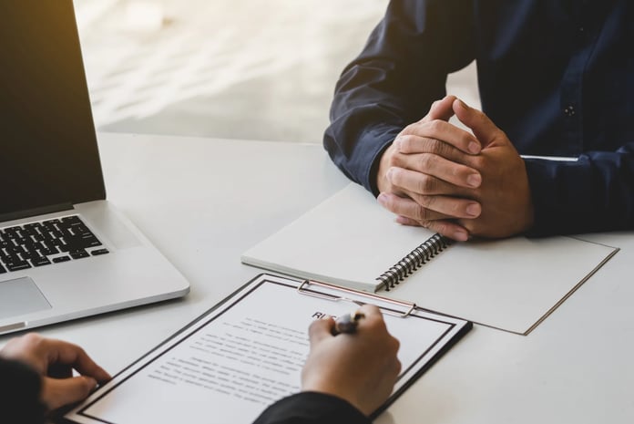 Job interviewer examining resume