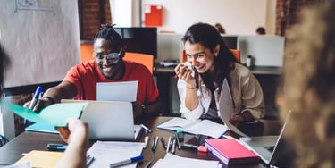 Laughing students working in a team