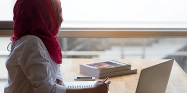 Student wearing head scarf looking left