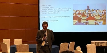 IELTS expert presenting at a higher education conference on English proficiency and student success