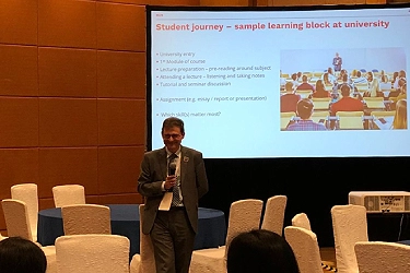 IELTS expert presenting at a higher education conference on English proficiency and student success