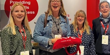 IELTS scholarship winners at IATEFL 2022 standing together at the IELTS stand