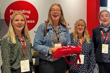 IELTS scholarship winners at IATEFL 2022 standing together at the IELTS stand