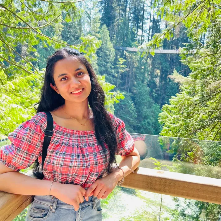 IELTS test taker standing on forest bridge viewpoint in Canada