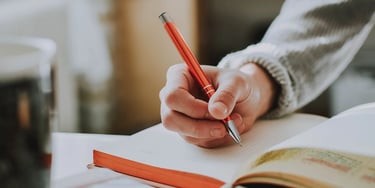 Close-up of hand writing in a notebook while studying
