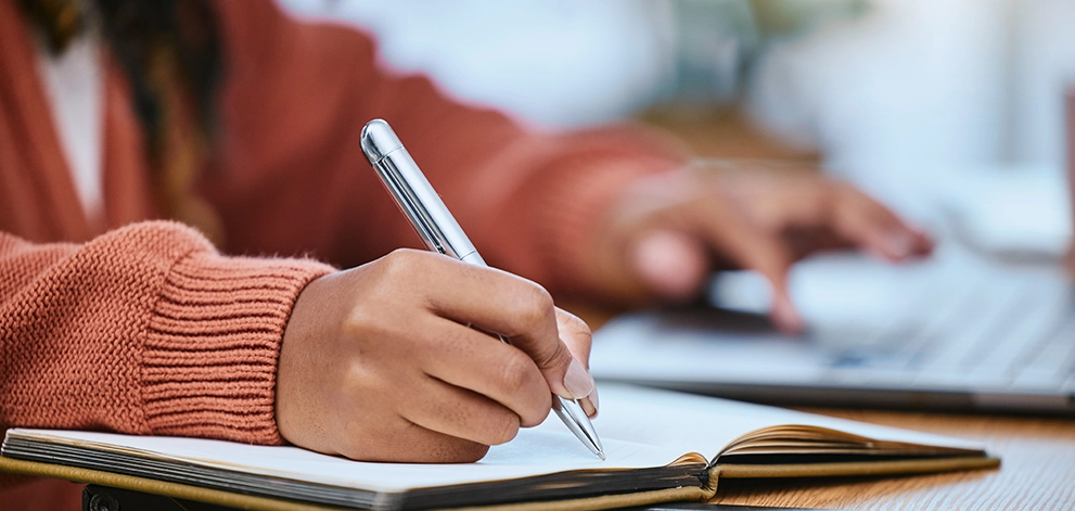 Student writing notes close-up