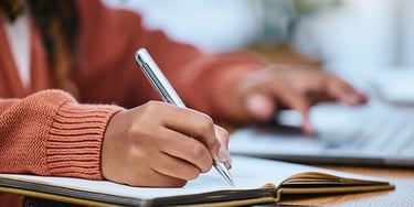 Student writing notes close-up