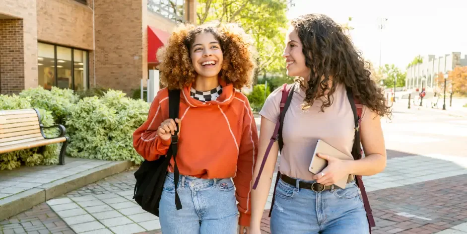 Two students walking on campus