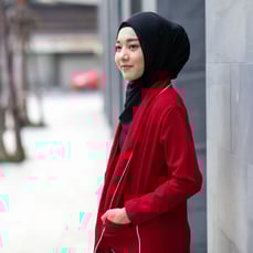 Professional woman wearing a headscarf standing in a city environment