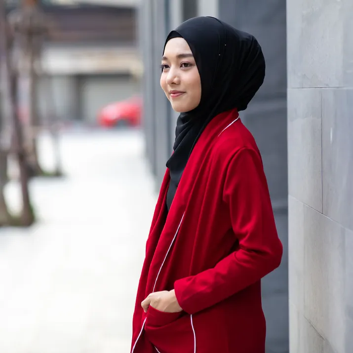 Professional woman wearing a headscarf standing in a city environment