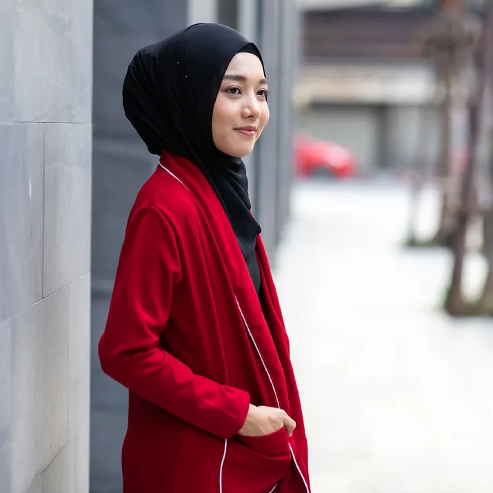 Professional woman wearing a headscarf standing in a city environment