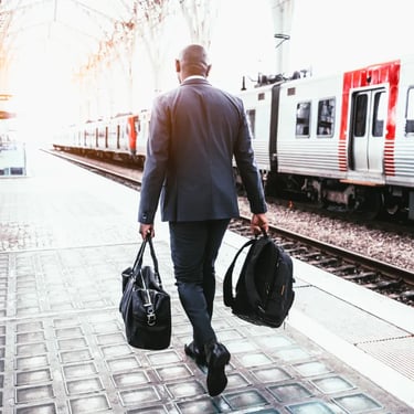 Professional traveller walking beside a train platform representing global opportunities with IELTS