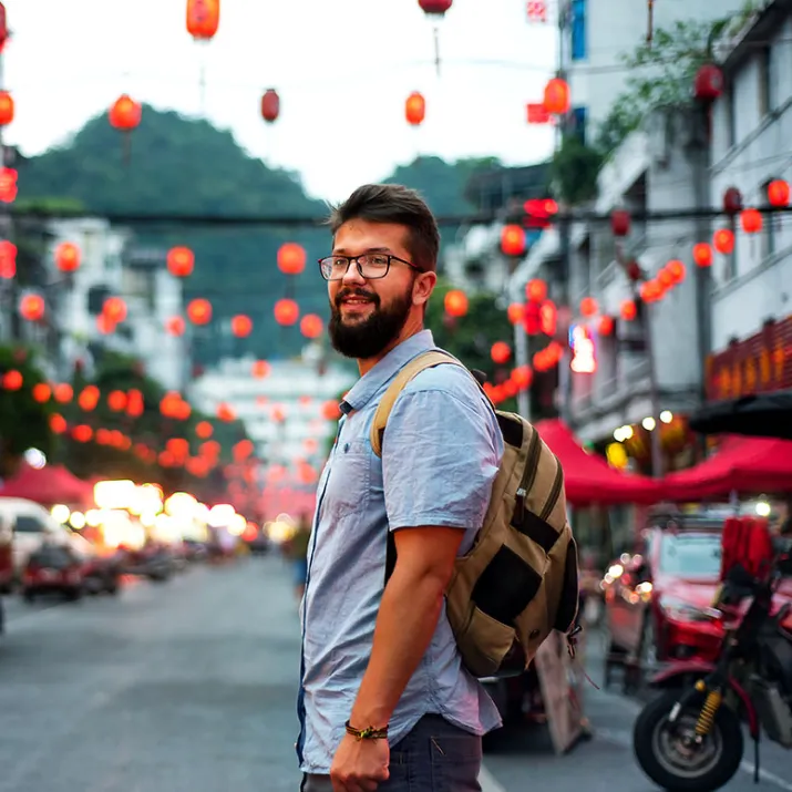 Traveller standing city street - left