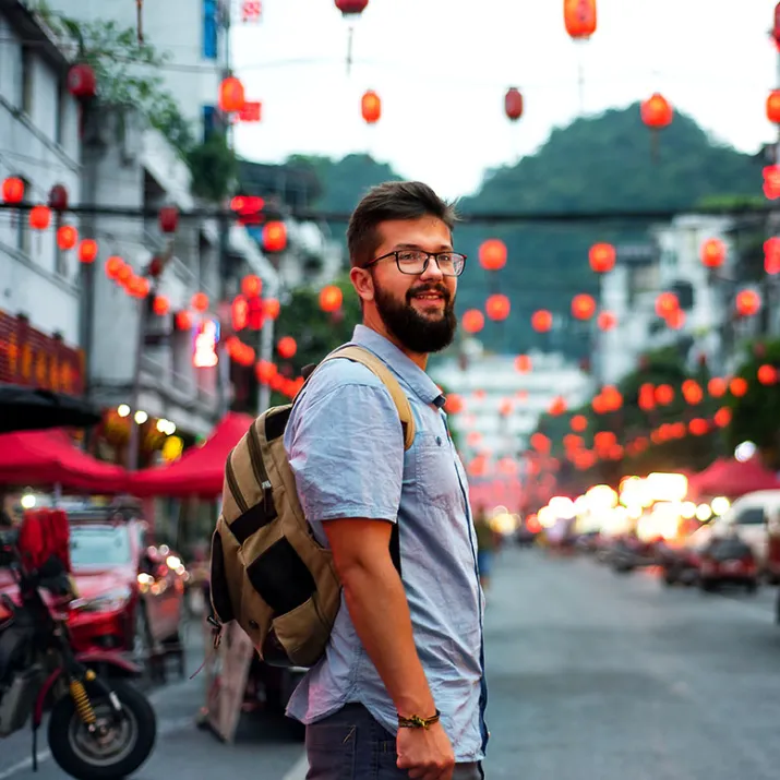 Traveller standing city street - right