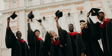 Group of graduates celebrating in front of a building