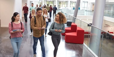 Students walking campus building