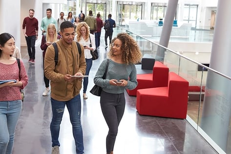 Students walking campus building