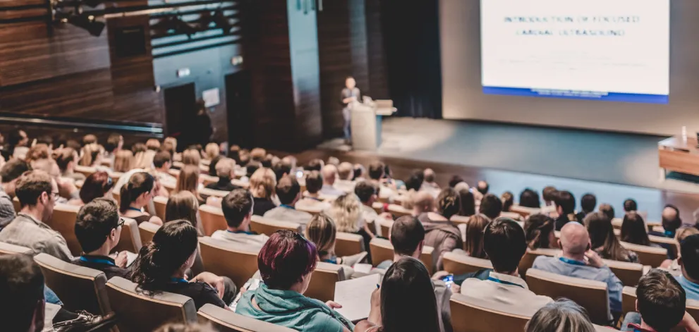 Speaker giving a talk in conference hall