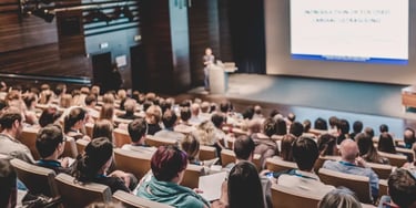 Speaker giving a talk in conference hall