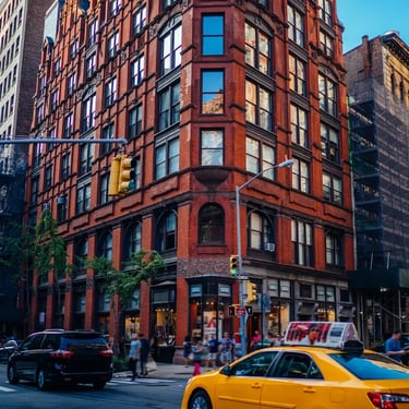 Busy New York City street with yellow taxi, pedestrians and tall buildings