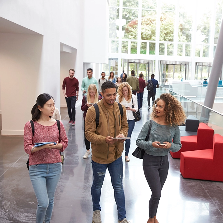 Students walking campus building