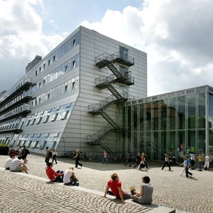 Students outside a modern university campus building