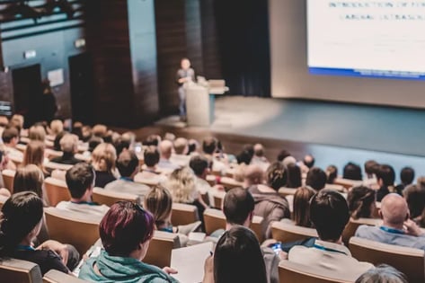Speaker giving a talk in conference hall