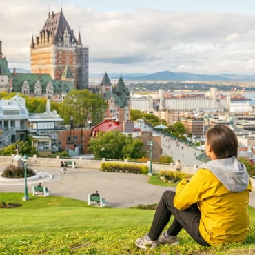Woman in yellow coat sitting in Quebec