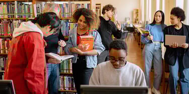 Group of students studying and reading books together in a library