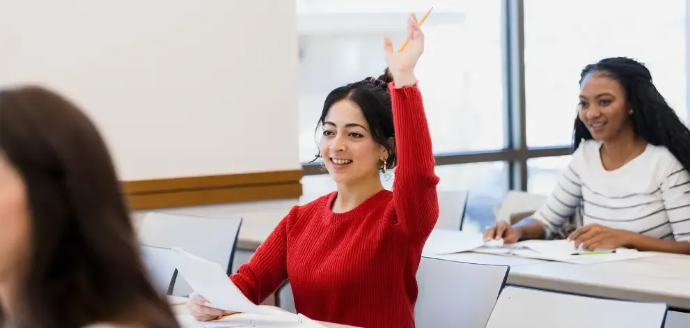 Student raising hand in classroom