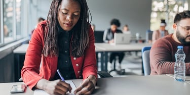 Student writing during a test in a classroom