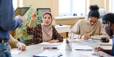 Teacher teaching a class of adults