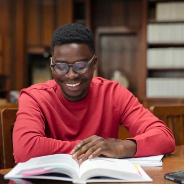 Student reading book library - left