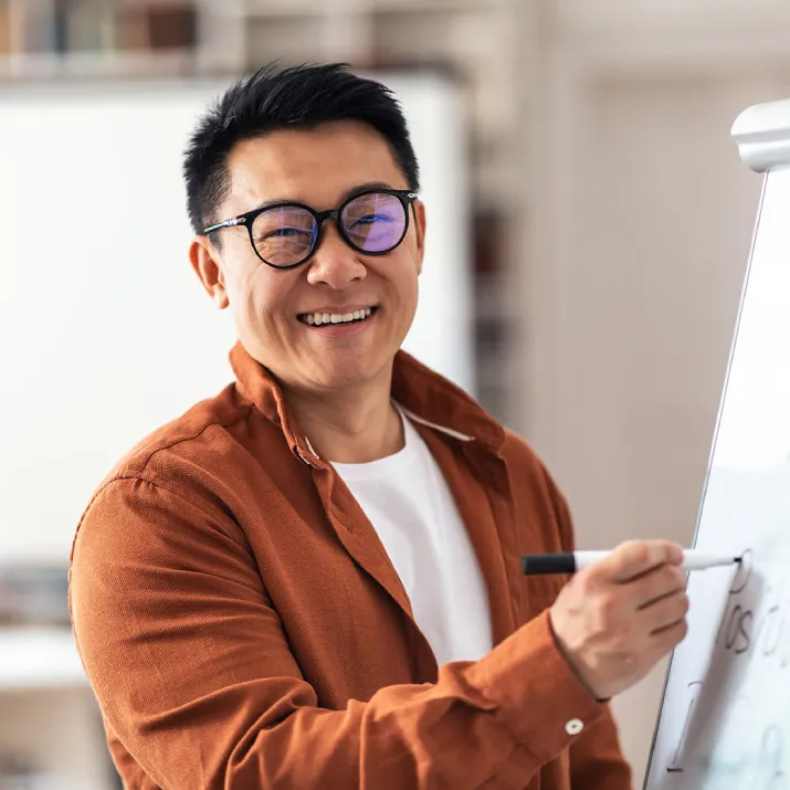 Teacher writing on whiteboard