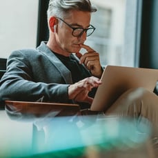 Man using laptop while seated