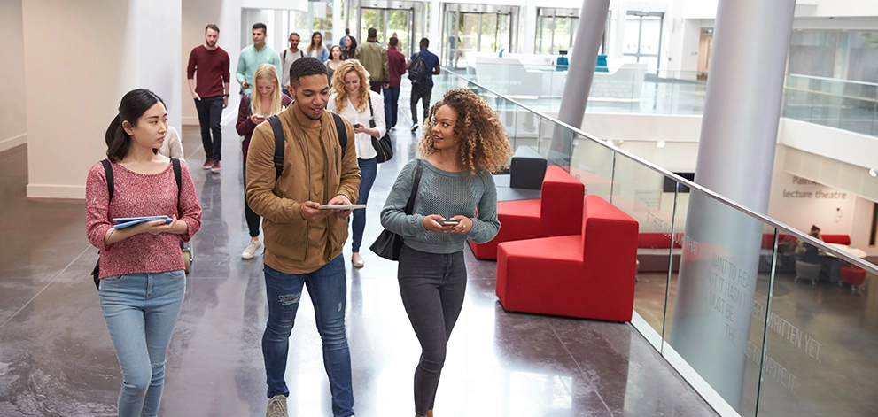 Students walking campus building